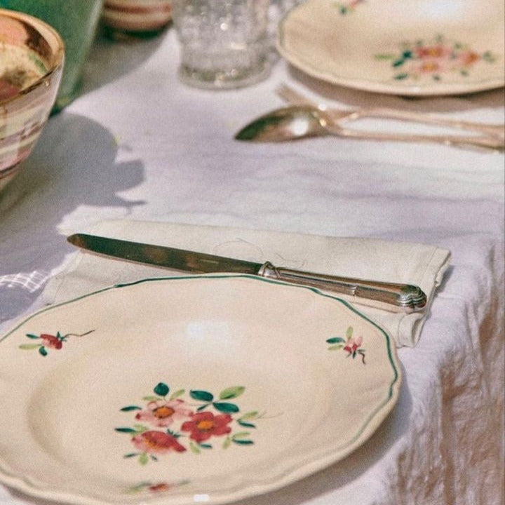 Floral china place setting on a linen table