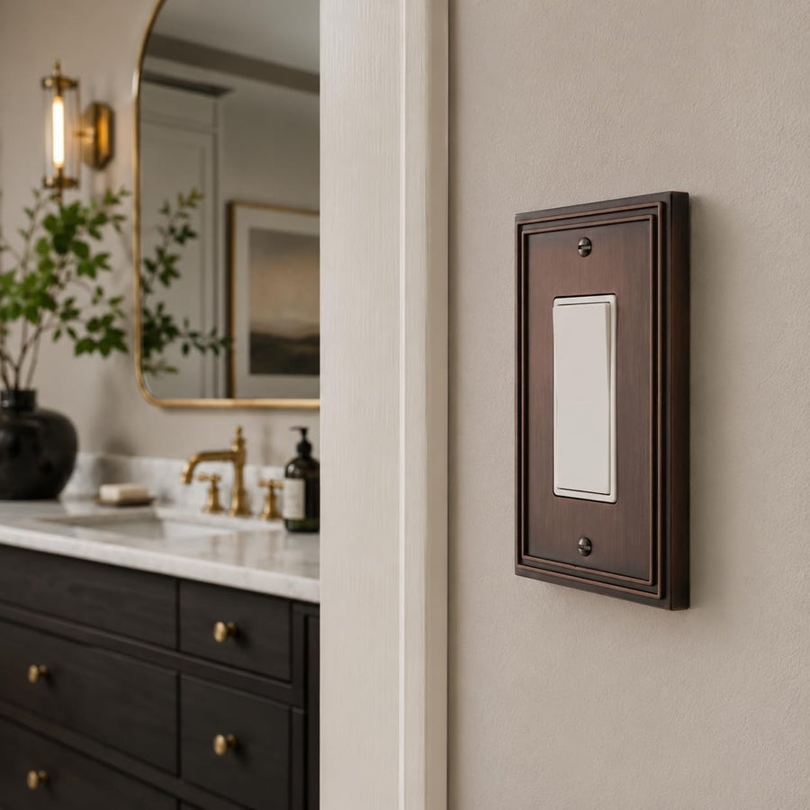 Imperial 1-gang rocker switch plate in Vintage Copper in a bathroom with a dark vanity