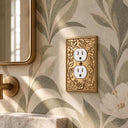 Botanical Garden Collection brushed gold outlet cover on leaf wallpaper