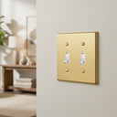 Signature 2-gang toggle switch plate in Brushed Brass, photo - lifestyle