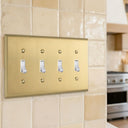 Signature 4-gang toggle switch plate in Brushed Brass, photo - lifestyle
