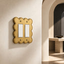 Scallop 2G Rocker Wall Plate in Brushed Gold in an entryway