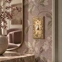 Botanical Garden 1G Toggle Wall Plate in Brushed Gold in a living room
