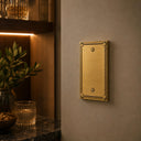 Pearl 1-gang blank wall plate in Brushed Gold, lifestyle pho
