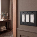 Pearl 3-gang rocker wall plate in Black, lifestyle photo