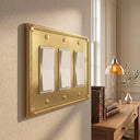 Pearl 3-gang rocker wall plate in Brushed Gold, lifestyle ph