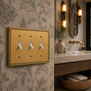 Pearl 3-gang toggle wall plate in Brushed Gold, lifestyle ph