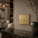 Pearl 3-gang toggle wall plate in Brushed Gold, lifestyle ph