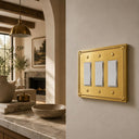 Pearl 3-gang rocker wall plate in Brushed Gold, lifestyle photo