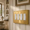 Pearl 4-gang rocker wall plate in Brushed Gold, lifestyle photo
