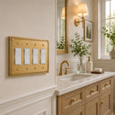 Pearl 4-gang rocker wall plate in Brushed Gold, lifestyle photo