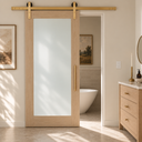 Light Gold sliding barn door hardware on a frosted glass oak door in a bright bathroom