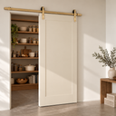 Light Gold barn door hardware on a white shaker sliding door opening to a pantry