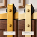 Dark Gold and Light Gold barn door hangers side by side on a dark wood door, Light Gold shown as the finish you are viewing