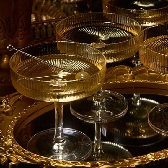 Champagne coupes on a gilded tray