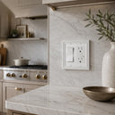 Estate 2-gang rocker switch plate in White on a light wall in a kitchen with a marble backsplash