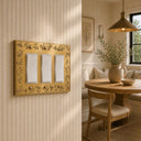Floral 3G Rocker wall plate in Brushed Gold on a wall in a styled room