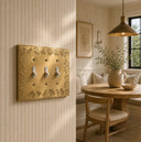 Floral 3G Toggle wall plate in Brushed Gold on a wall in a styled room