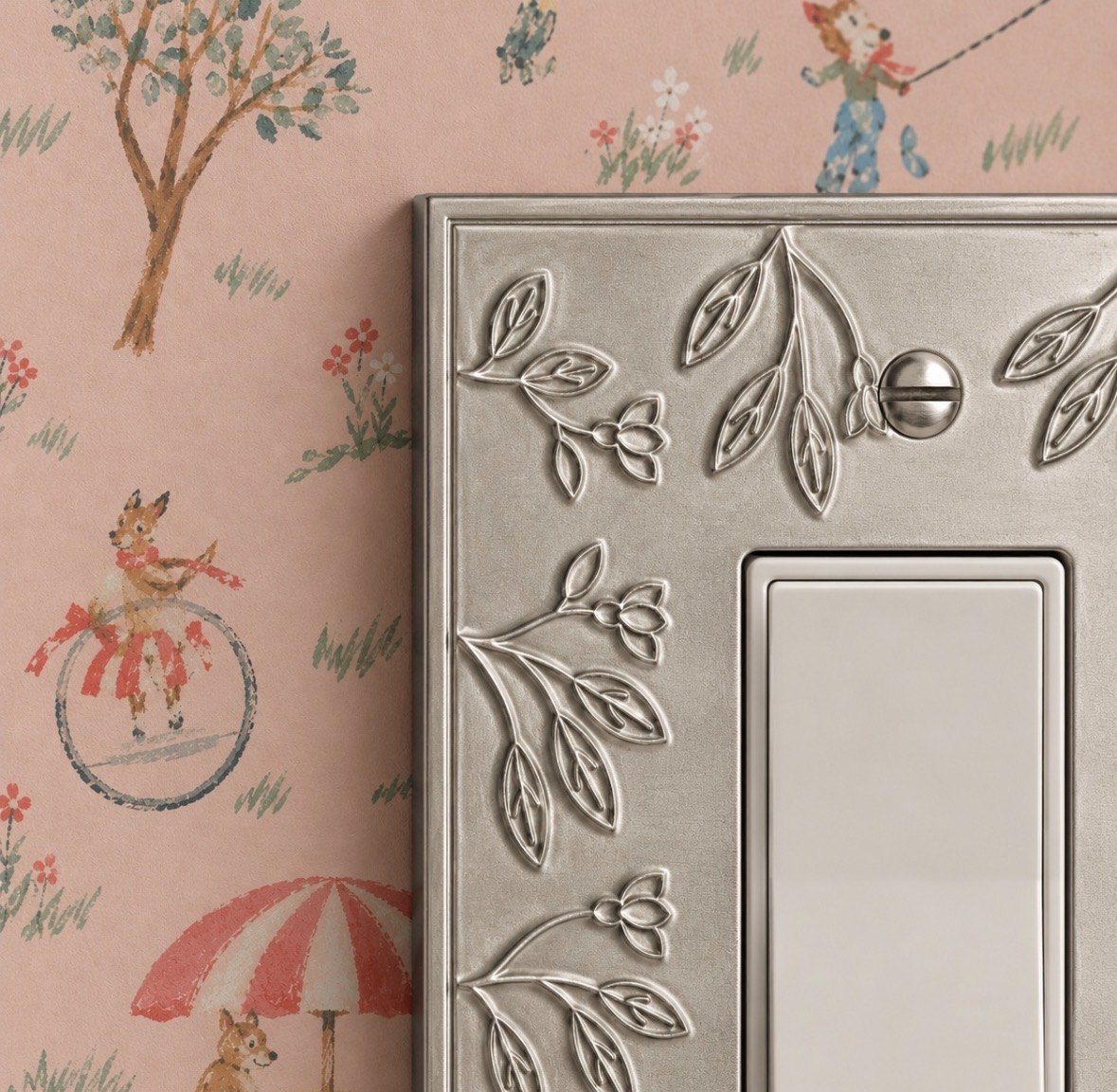 Close-up of a wall plate with raised floral relief in Brushed Nickel