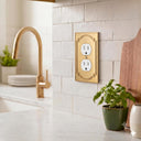 Heritage 1G Duplex wall plate in Brushed Gold on a wall in a styled room