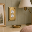 Honey Bee 1G Duplex Wall Plate in Brushed Gold in a bedroom