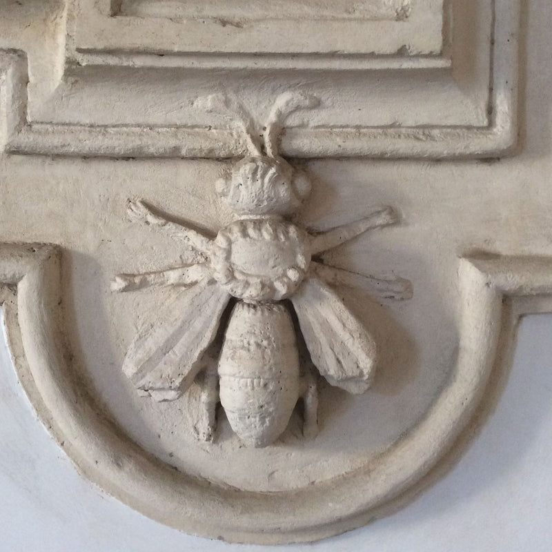 Plaster bee relief