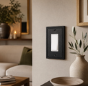 Imperial 1G Rocker switch plate in Black in a cozy living room