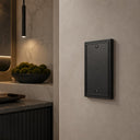 Imperial 1G Blank wall plate in Black on a wall in a styled room