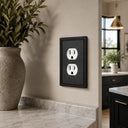 Imperial 1G Duplex wall plate in Black on a wall in a styled room