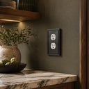 Imperial 1G Duplex wall plate in Black on a wall in a styled room
