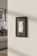 Imperial 1G Rocker wall plate in Black on a wall in a styled room
