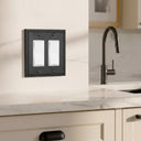 Imperial 2G Rocker wall plate in Black on a wall in a styled room