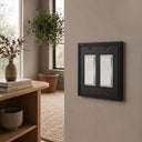 Imperial 2G Rocker wall plate in Black on a wall in a styled room