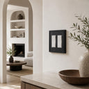 Imperial 2G Rocker wall plate in Black on a wall in a styled room