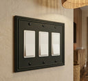 Imperial 3G Rocker wall plate in Black on a wall in a styled room
