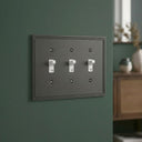 Imperial 3G Toggle wall plate in Black on a wall in a styled room