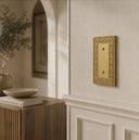 Laurel 1G Blank wall plate in Brushed Gold on a wall in a styled room