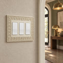 Laurel 3G Rocker wall plate in Warm Ivory on a wall in a styled room