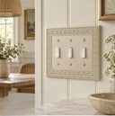 Laurel 3G Toggle wall plate in Warm Ivory on a wall in a styled room