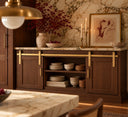 Walnut credenza against a marble wall with two sliding doors on a Gold mini barn door rail