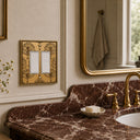 Nouveau 2G Rocker Wall Plate in Brushed Gold in a bathroom