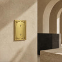 Palazzo 1G Blank wall plate in Brushed Gold on a wall in a styled room