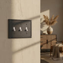 Pearl 3-gang toggle wall plate in Black, lifestyle photo