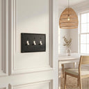 Pearl 3-gang toggle wall plate in Black, lifestyle photo