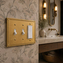 Pearl 3G RTT Combo wall plate in Brushed Gold on a wall in a styled room