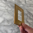 Pearl Brushed Gold wall plate handled close up to show weight and finish