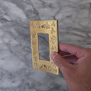 Floral Brushed Gold wall plate handled close up to show weight and finish