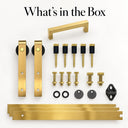Gold mini barn door kit for one cabinet door, what's in the box: rail sections, 2 hangers with rollers, mounting hardware, 1 pull handle and 1 floor guide