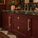 Light Gold 12 in round barn door handles on a burgundy bathroom vanity with greenery