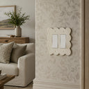 Scallop 2G Rocker Wall Plate in Warm Ivory in a living room